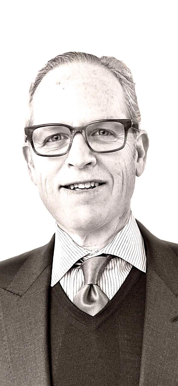 professional executive portrait of a senior male leader in a modern office environment