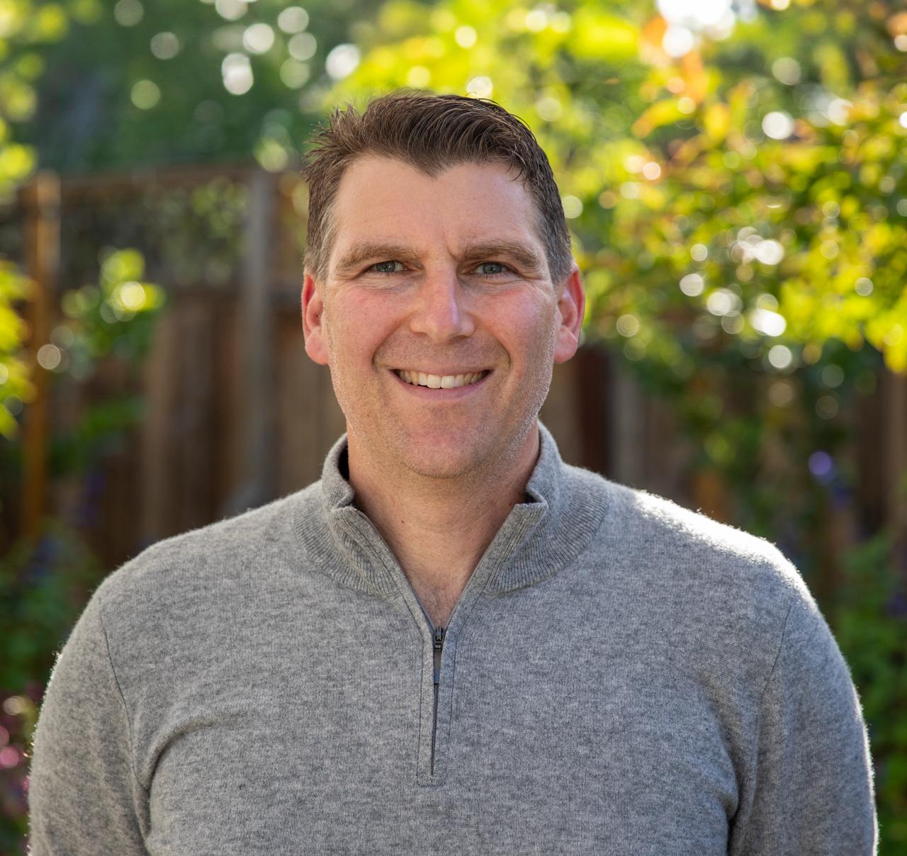 professional executive portrait of a middle-aged male leader with a background of modern architecture